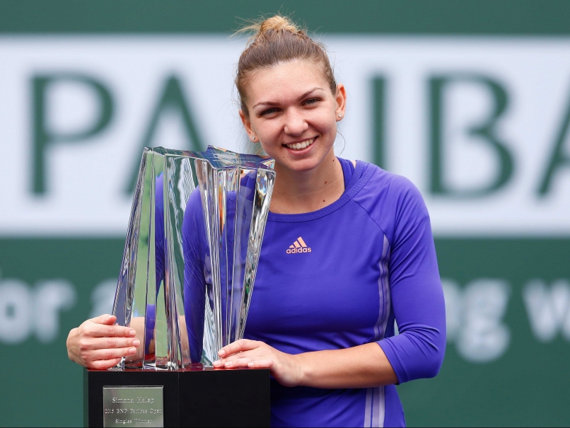 Simona Halep of Romania poses with her trophy after defeating Jelena Jankovic of Serbia in the women's final of the BNP Paribas Tennis Open in Indian Wells, California on Sunday.