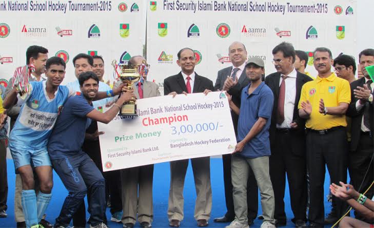 Team Leader of Khanjanpur High School of Joypurhat receiving the champions trophy of the First Security Islami Bank National School Hockey Competition from State Minister for Youth and Sports Biren Sikder at the Moulana Bhashani National Hockey Stadium on