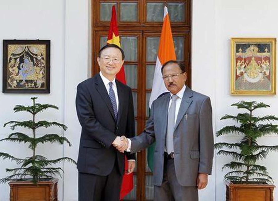 China's State Councillor Yang Jiechi (L) and India's National Security Advisor Ajit Doval shake hands during a photo opportunity before their meeting in New Delhi on Monday.