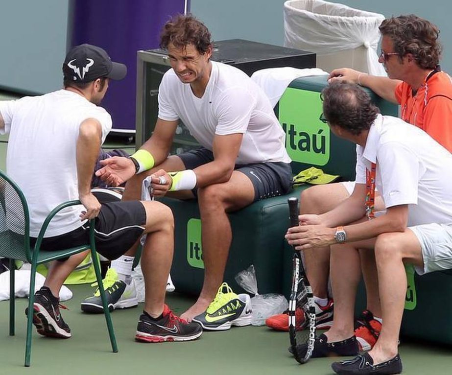Rafael Nadal grimaces after tripping during a practice session at the Miami Open in Key Biscayne on Monday.