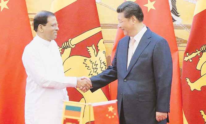Sri Lankan President Maithripala Sirisena shakes hands with Chinese President Xi Jinping at a signing ceremony in the Great Hall of the People.