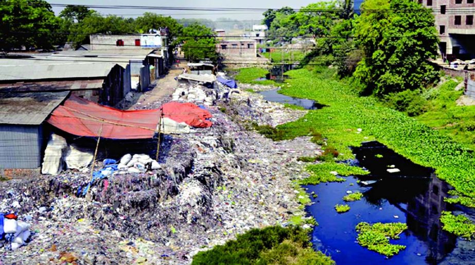 Affluent people continue to dump garbage in a bid to grab the land of connecting Khal with Turag River adjacent to Savar. This photo was taken from Savar-Aricha Highway on Friday.