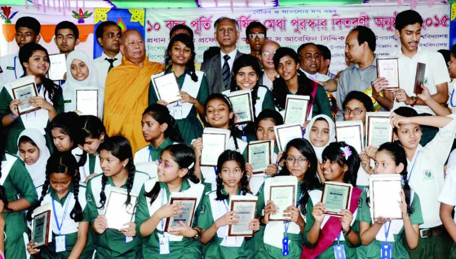 Dhaka University Vice-Chancellor Prof Dr AAMS Arefin Siddique and other distinguished persons along with the recipients of merit prize pose for photograph at a ceremony organized by Banophool Adibashi Green Heart College at its premises in the city on Sat