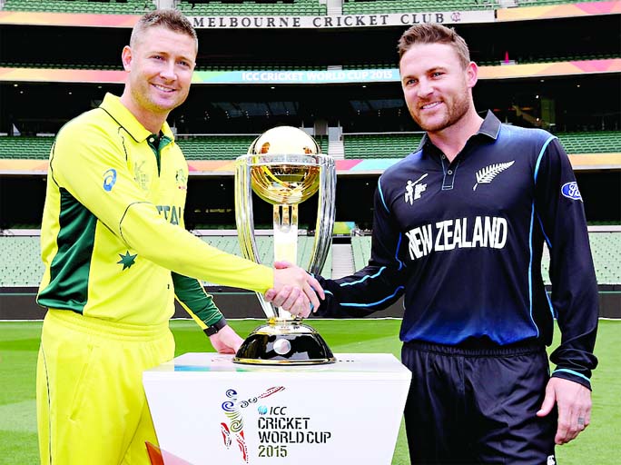 Captains Michael Clarke (L) of Australia and Brendon McCullum on New Zealand shaking hands in front of the World Cup trophy during the ICC Cricket World Cup Final press conference at Melbourne Cricket Grouand on Saturday.