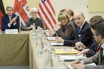 US Secretary of State, John Kerry, left, US Under Secretary for Political Affairs, Wendy Sherman, 2nd left, French Foreign Minister, Laurent Fabius, right, and others wait for the start of a trilateral meeting at an hotel in Lausanne on Saturday.