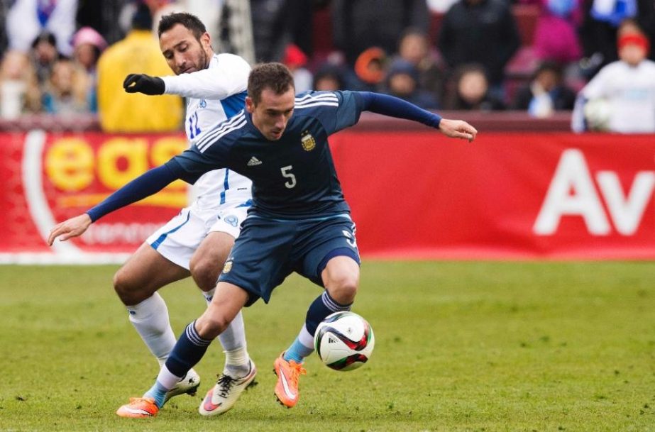 Argentina's Federico Mancuello (R) vies for the ball against El Salvador's Arturo Alverez during an international friendly match at Fedex Field in Landover, Maryland on Saturday.