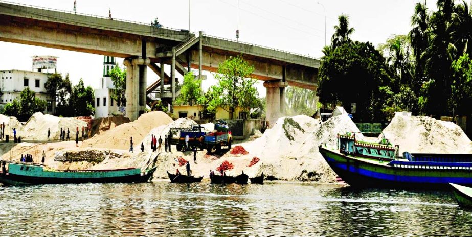 Local influentials continue extraction of sands illegally from Shitalakkhya River and dumping it under Sultana Kamal Bridge side despite Court order. This photo was taken from Demra on Monday.