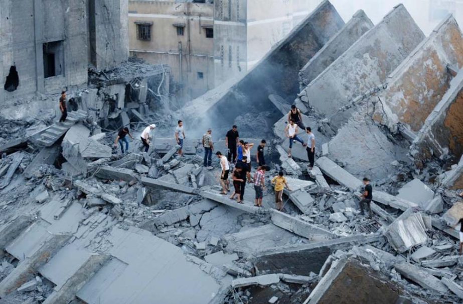 Palestinians inspect the remains of a building destroyed by an Israeli air strike in Gaza City.
