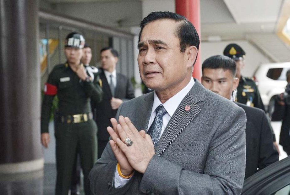 Thailand's Prime Minister Prayuth Chan-ocha (C) gestures in a traditional greeting after a speech at the Stock Exchange of Thailand in Bangkok.