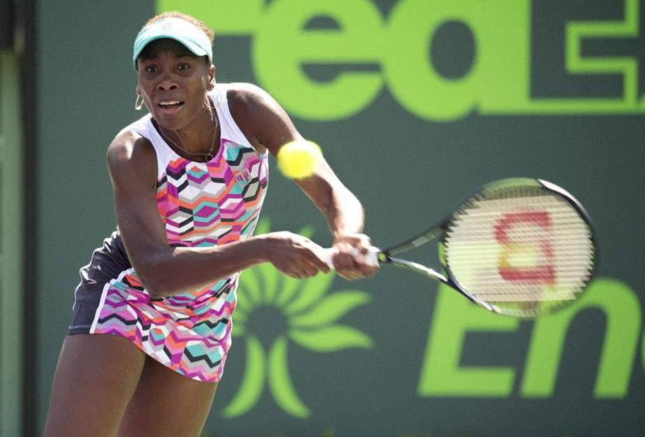 Venus Williams returns the ball to Caroline Wozniacki during their match at the Miami Open tennis tournament in Key Biscayne, Fla on Monday.