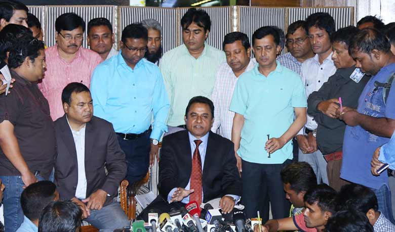Mustafa Kamal (C) addresses journalists at the Shahjalal International Airport in Dhaka