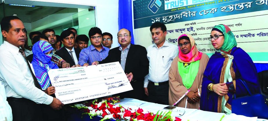 Md Abdul Hai, Chairman of Trust Islami Life Insurance Limited, handing over death claim cheque of Tk 10lac to Khairul Anam at its head office recently.