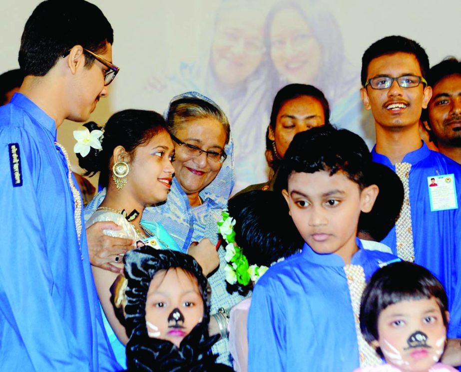 Prime Minister Sheikh Hasina along with the autistic children poses for photograph at Bangabandhu International Conference Center in the city on Thursday on the occasion of World Autism Awareness Day. BSS photo