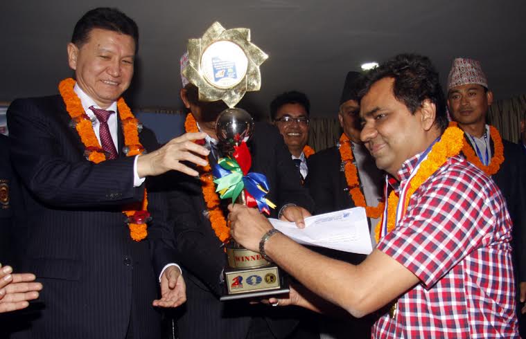 GM Ziaur Rahman (right), the champions of the Asian Zonal (Zone-3,2) Chess Championship receiving trophy, gold medal and 1500 US dollars at Kathmandu, the capital city of Nepal on Wednesday.