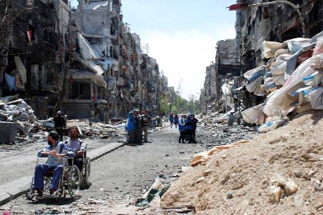 Residents of Syria's besieged Yarmuk Palestinian refugee camp, south of Damascus, gathering to receive food aid from UNRWA