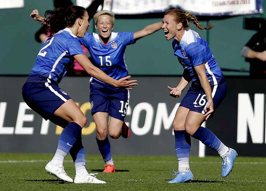 United States' Lori Chalupny (right) is congratulated by teammates Lauren Holiday (left) and Megan Rapinoe after scoring during the second half of an exhibition soccer match against New Zealand on Saturday in St. Louis. The United States won 4-0.