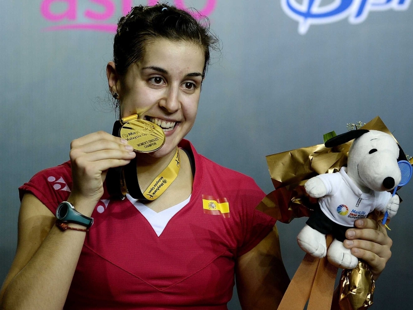 Spain's Carolina Marin bites her medal after clinched the women's singles title in the $500,000 Malaysia Open Super series Premier badminton tournament at the Putra Stadium on Sunday.