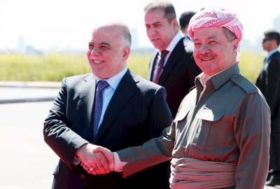 Iraqi Kurdish regional President Massoud Barzani (R) shakes hands with Iraqi Prime Minister Haider al-Abadi at Arbil International Airport
