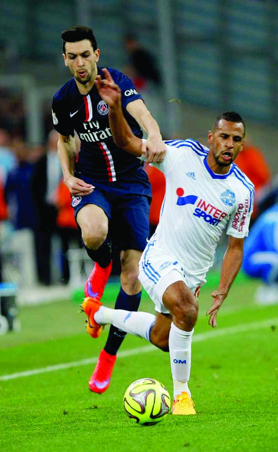 Marseille's Jacques-Alaixys Romao (right) challenges Paris Saint Germain's Argentinean midfielder Javier Pastore for the ball, during the League One soccer match between Marseille and Paris Saint-Germain at the Velodrome Stadium in Marseille, southern F
