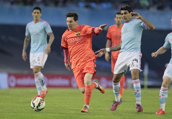 Barcelona's Lionel Messi from Argentina (2nd left) and RC Celtaâ€™s Augusto Fernandez from Argentina during a Spanish La Liga soccer match between RC Celta and Barcelona at the BalaÃ­dos stadium in Vigo, Spain on Sunday.