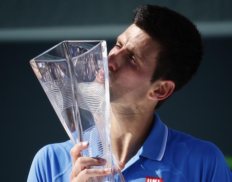 Novak Djokovic, of Serbia, kisses the trophy after he defeated Andy Murray of Great Britain during the men's final match at the Miami Open tennis tournament in Key Biscayne, Fla on Sunday. Djokovic won 7-6 (3), 4-6, 6-0.