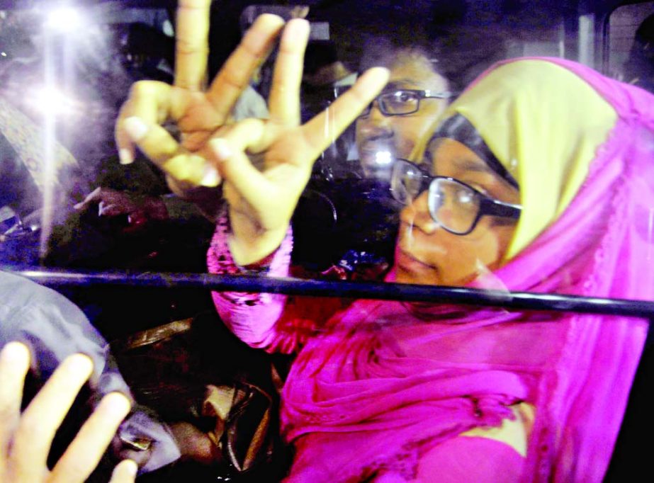 Wife of Kamaruzzaman and other family members showing V-sign when they went to meet the death-row convict at Dhaka Central Jail on Monday.