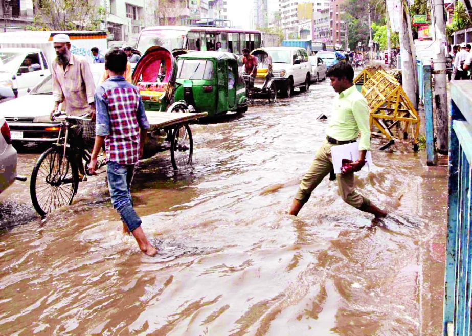 Rain waters remain stagnant in city's Fakirerpool area due to poor drainage system disrupting movement of dwellers as well as vehicles on Monday.
