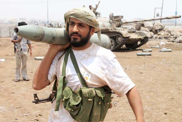 A supporter of the Yemeni separatist Southern Movement carries tank shell on his shoulder in the southern port city of Aden.