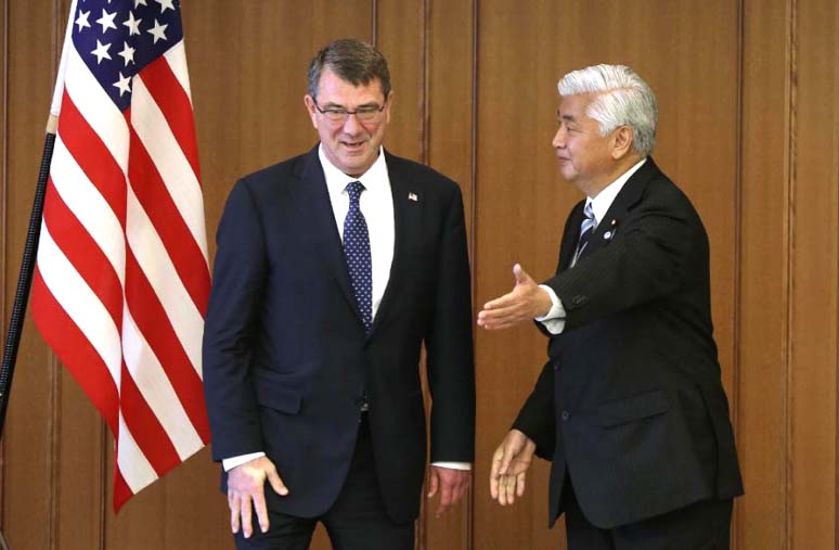 US Defence Secretary Ash Carter, left, is escorted by Japan's Defence Minister Gen Nakatani during a meeting at the Defence Ministry in Tokyo on Wednesday.