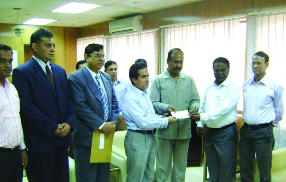 State Minister for Labour & Employment Md Mujibul Haque Chunnu, receiving a cheque of over Tk 11million from Md Mosharraf Hossain Bhuiyan, ndc, Secretary MP, Ministry of Industries & Chairman of KAFCO for Sramik Kalyan Foundation at the ministry on Tuesda