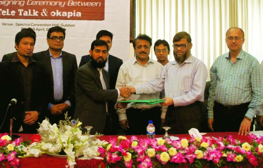 Gias Uddin Ahmed, Managing Director of Teletalk and Md Tofazzul Hossain, Managing Director of OKAPIA Mobile, a mobile handset brand, sign MoU for joint promotional package named-"Teletalk-OKAPIA Double Ushul Offer" at a city convention center on Thursda