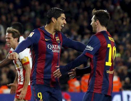 Barcelona's Lionel Messi (R) and Luis Suarez celebrate a goal against Almeria during their Spanish first division soccer match at Camp Nou stadium in Barcelona on Wednesday.