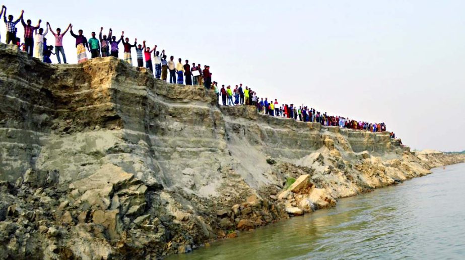Inhabitants of Nabaganga area of Poba upazila formed a human chain on the bank of the Padma River on Thursday to help protect the embankment from its erosion ahead of rainy season.