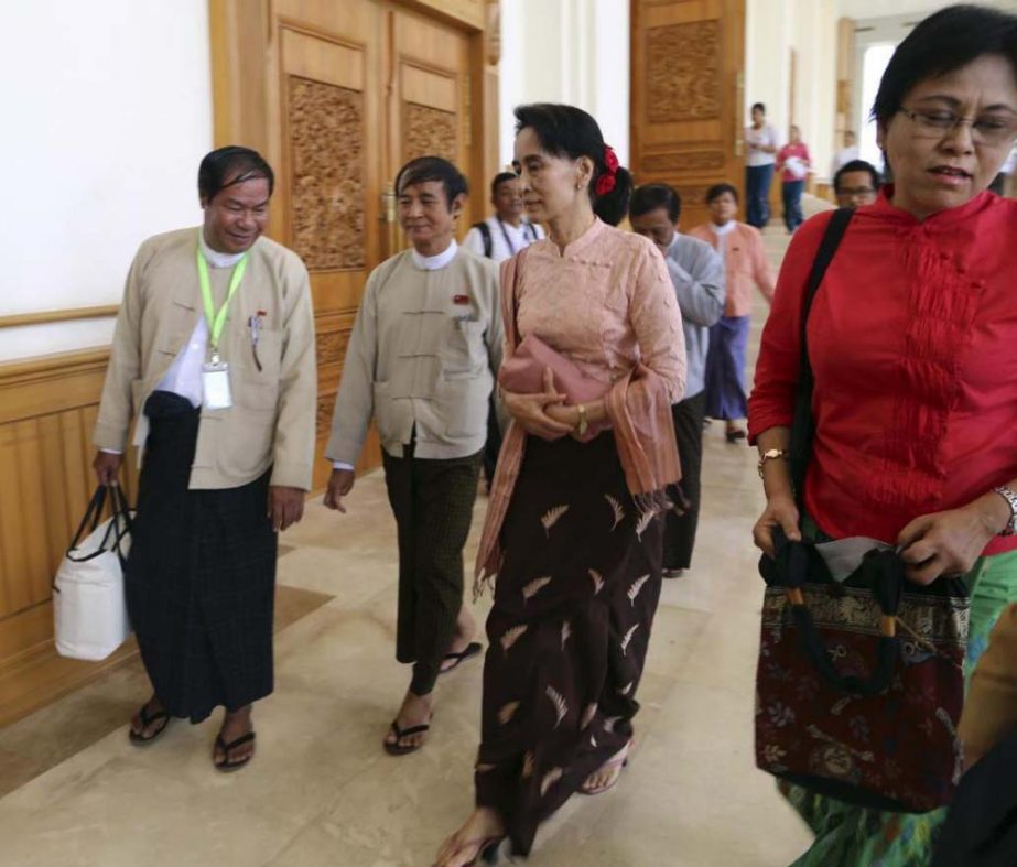 Myanmar opposition leader Aung San Suu Kyi, second right, walks as she attends a regular session of the lower house of parliament on Thursday in Naypyitaw.