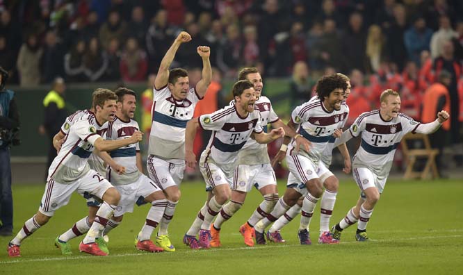 Bayern players celebrate after winning 5-3 in the penalty shoot-out of German soccer cup quarter final match between Bayer 04 Leverkusen and Bayern Munich in Leverkusen, western Germany on Wednesday.