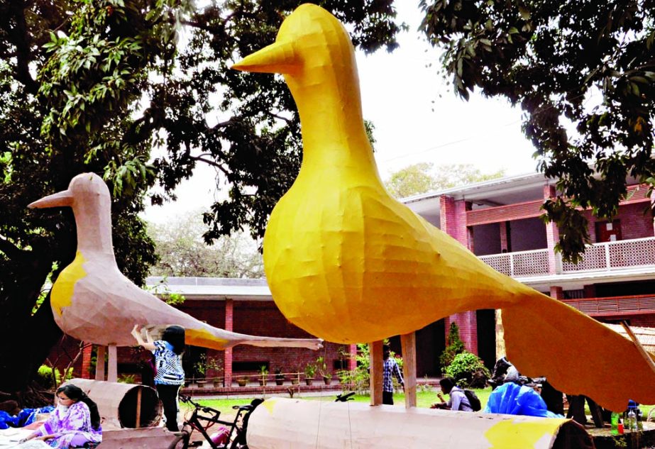 Preparations for celebrating Pahela Baishakh near complete. The students of the DU Faculty of Fine Arts are seen giving final touches to the replica of pigeon symbol of peace. This photo was taken on Sunday.
