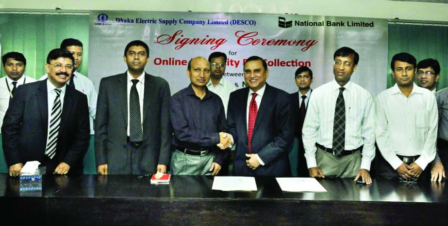 Shamsul Huda Khan, Managing Director of National Bank Limited and Engr Zulfikar Tahmid, Company Secretary of DESCO, exchanging documents after signing an agreement in the city on Sunday. Under the deal DESCO clients will be able to pay their electricity b