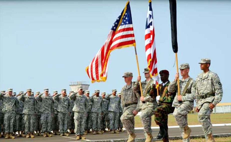 US troops seen at a march- past in a base.