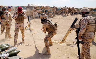 Iraqi army soldiers fire a mortar during clashes with Islamic State militants in the Karma district of Anbar province