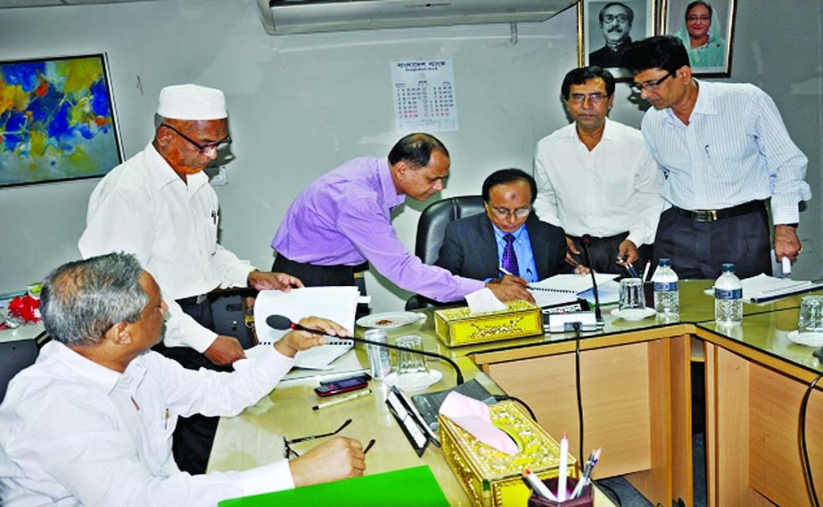 Mohammad Ismail, Chairman of the Board of Directors of Bangladesh Krishi Bank, signing board approved Balance Sheet of the year 2014 at its head office on Thursday.