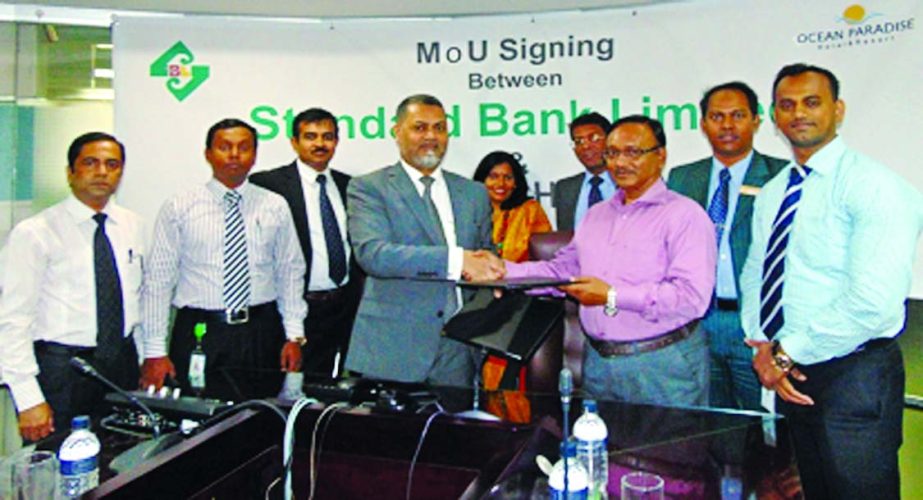 Mamun-Ur- Rashid, Deputy Managing Director of Standard Bank Limited and MN Karim, Chairman of Ocean Paradise Hotel & Resort sign an agreement at the bank's board room recently. Under the agreement VISA cardholders and employees of the bank will get 50 pe