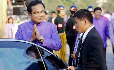 Thailand's Prime Minister Prayuth Chan-ocha gestures the traditional greeting as he gets in his car in Bangkok.