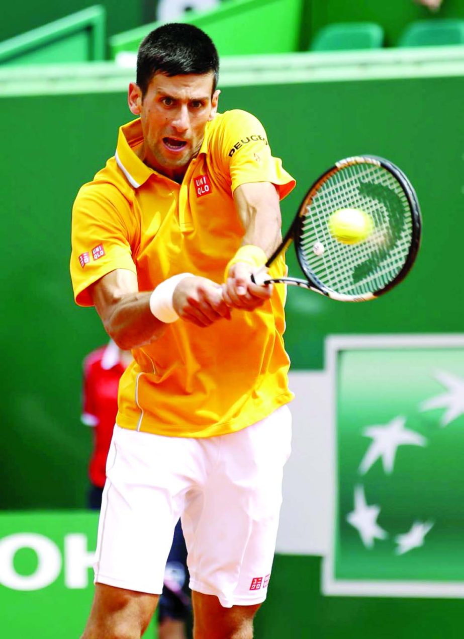 Novak Djokovic of Serbia plays a return to Marin Cilic of Croatia during their quarterfinal match of the Monte Carlo Tennis Masters tournament in Monaco on Friday.