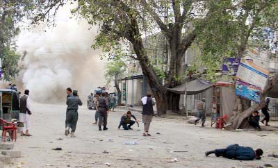 Afghan security react at the scene of a suicide bomb attack in Jalalabad, Afghanistan on Saturday.