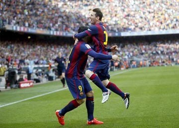 Barcelona's Lionel Messi (R) and Luis Suarez celebrate a goal against Valencia during their Spanish first division soccer match at Camp Nou stadium in Barcelona on Saturday.