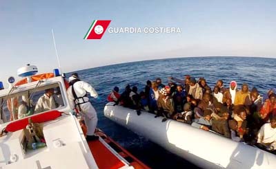 A video grab released by the Italian Coast Guards (Guardia Costiera) on Friday shows migrants wait in a boat during a rescue operation.