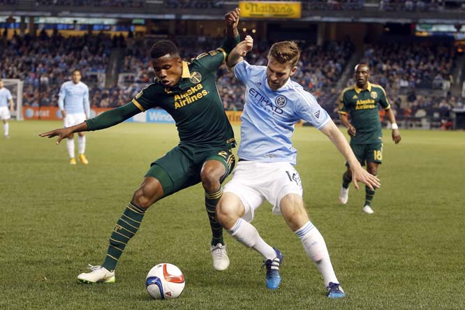 Portland Timbers' Alvas Powell (2) of Jamaica defends New York City FC's Patrick Mullins (14) during an MLS soccer game at Yankee Stadium in New York on Sunday.
