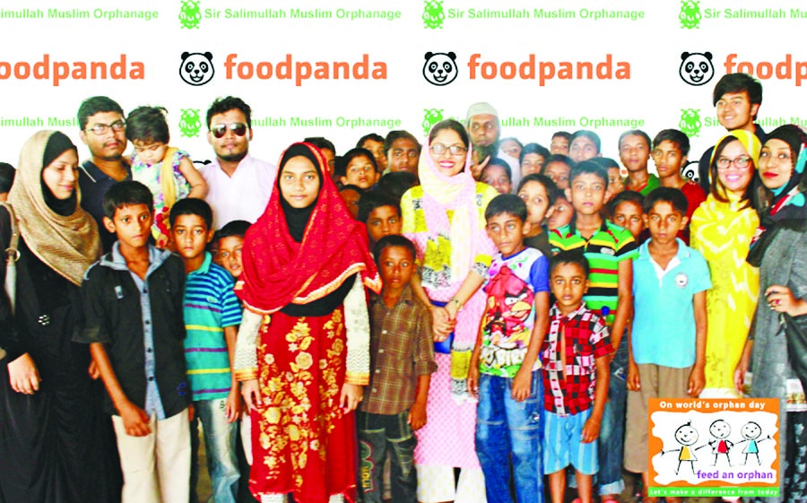 Sakerina Khaled, Marketing and Creative Coordinator; Ashreen Ahmed, Content Manager of Foodpanda pose with orphans of Sir Salimullah Muslim Orphanage on the occasion of World Orphans Day at the orphanage in the city on Sunday. The officials of the orphana