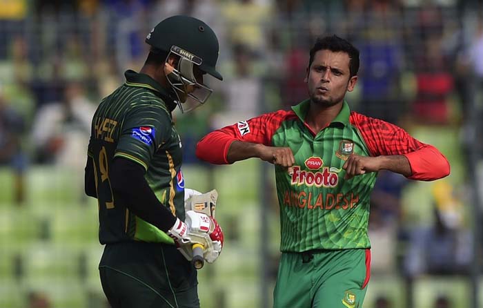 Bangladesh cricketer Arafat Sunny (R) reacts after the dismissal of the Pakistan cricketer Mohammad Hafeez (L) during the third One Day International cricket match between Bangladesh and Pakistan at the Sher-e-Bangla National Cricket Stadium in Dhaka on W