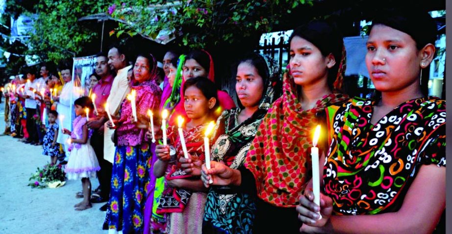 Bangladesh RMG workers formed a human chain with candlelight in front of Jatiya Press Club marking the 2nd anniversary of Rana Plaza Tragedy on Thursday.